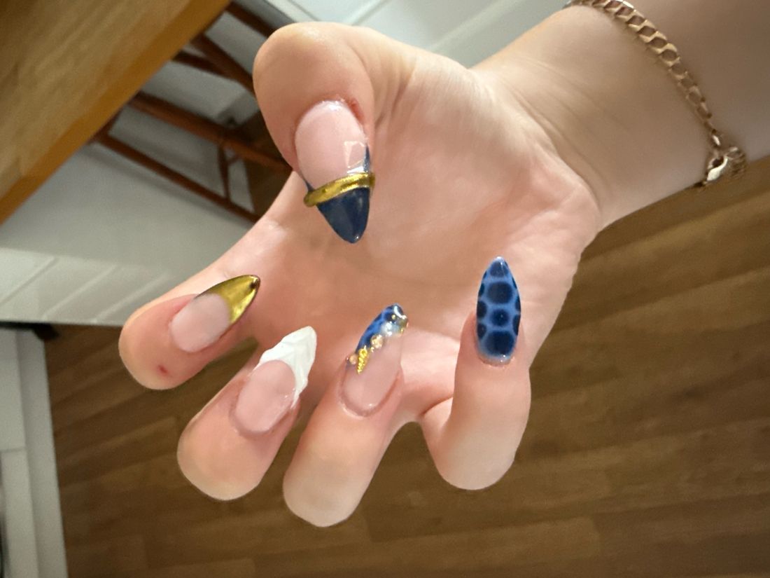 Almond nails in navy and gold with white French tips